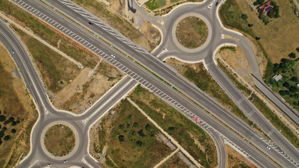 Aerial drone photo of modern motorway roundabouts of Ionia Odos near famous cable bridge of Rio - Antirio Harilaos Trikoupis, Antirio, Greece